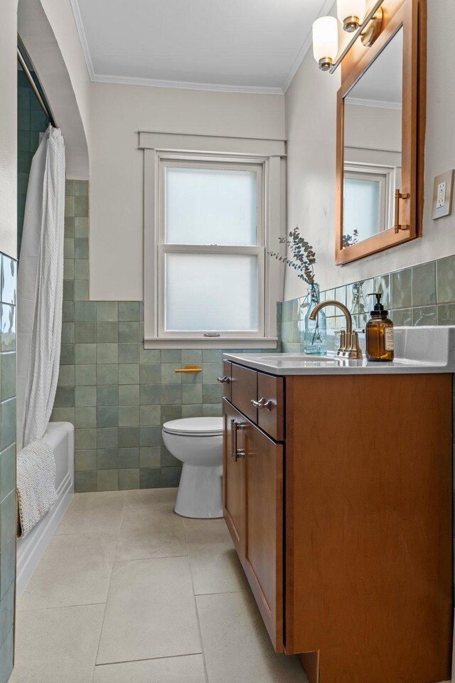 947 Stryker Ave W, Saint Paul, MN 55118 - full bath with tile walls, vanity, crown molding, shower / bath combination with curtain, and tile patterned floors