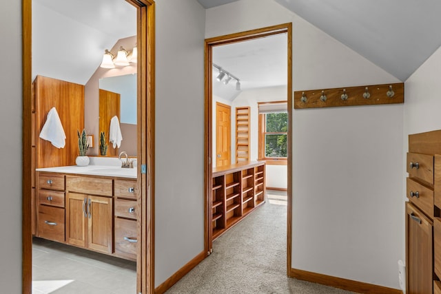 947 Stryker Ave W, Saint Paul, MN 55118 - bathroom featuring vaulted ceiling, vanity, and rail lighting