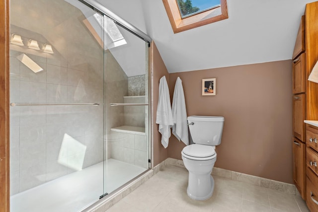 947 Stryker Ave W, Saint Paul, MN 55118 - bathroom featuring a skylight, vanity, vaulted ceiling, a shower stall, and tile patterned flooring