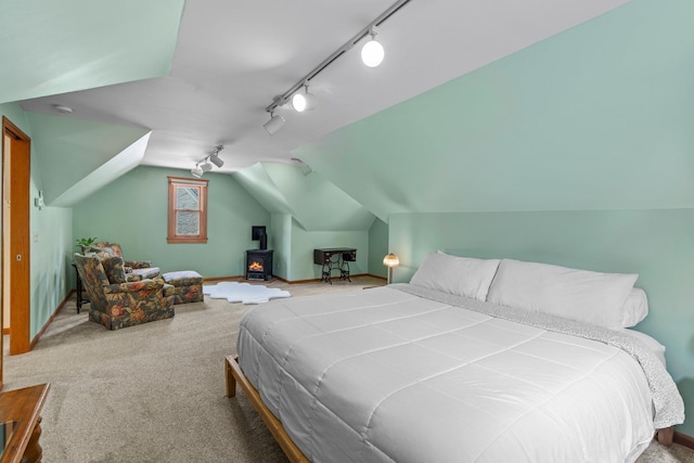 947 Stryker Ave W, Saint Paul, MN 55118 - carpeted bedroom with track lighting, vaulted ceiling, and a wood stove