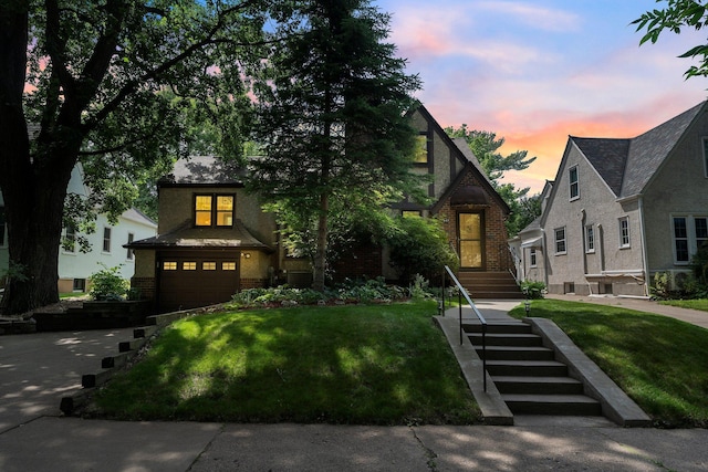 947 Stryker Ave W, Saint Paul, MN 55118 - view of front of house featuring brick siding, a front lawn, and a garage