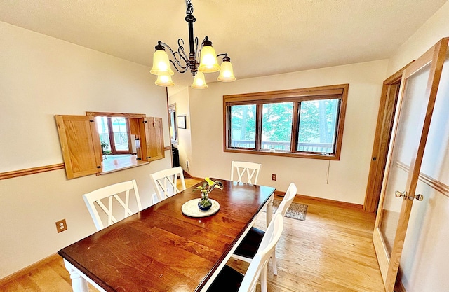 44512 276th Ln, Aitkin, MN 56431 - dining area featuring light wood finished floors and a chandelier