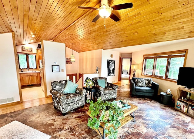 44512 276th Ln, Aitkin, MN 56431 - living room featuring wooden ceiling, stone finish floors, a ceiling fan, and vaulted ceiling