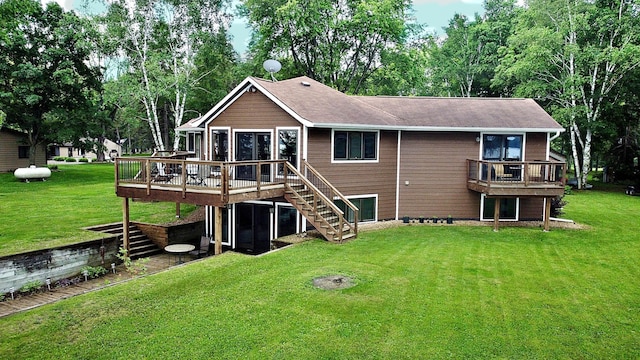 44512 276th Ln, Aitkin, MN 56431 - back of house featuring stairway, a wooden deck, and a lawn