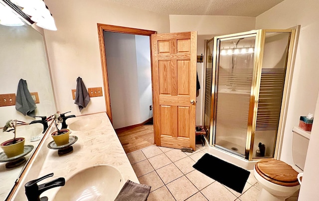44512 276th Ln, Aitkin, MN 56431 - full bathroom with a shower stall, tile patterned floors, double vanity, and a textured ceiling