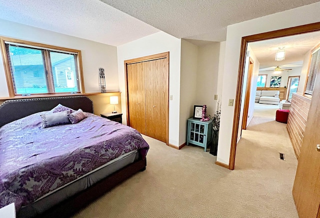 44512 276th Ln, Aitkin, MN 56431 - bedroom with light colored carpet, multiple windows, a closet, and a textured ceiling