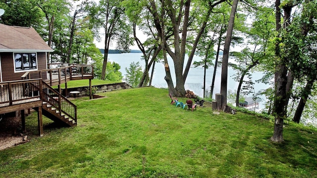 44512 276th Ln, Aitkin, MN 56431 - view of green lawn with stairway and a deck with water view