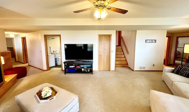 44512 276th Ln, Aitkin, MN 56431 - living room with washer / dryer, stairs, light colored carpet, and a ceiling fan