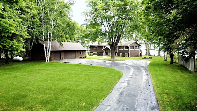 44512 276th Ln, Aitkin, MN 56431 - view of front facade featuring a garage, an outbuilding, and a front lawn
