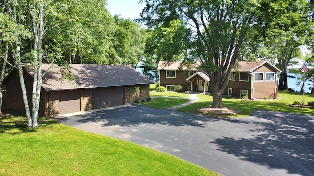 44512 276th Ln, Aitkin, MN 56431 - view of front of property with a detached garage, a front yard, and an outdoor structure