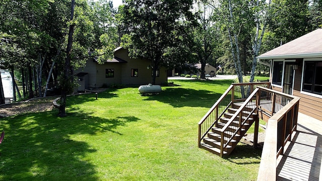 44512 276th Ln, Aitkin, MN 56431 - view of green lawn with a sunroom and stairs