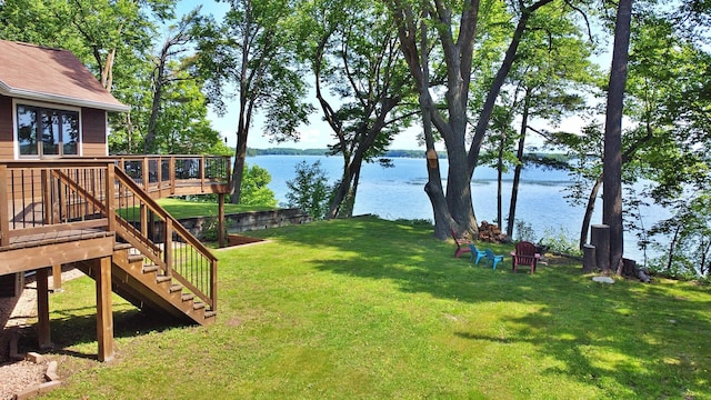 44512 276th Ln, Aitkin, MN 56431 - view of green lawn with stairway and a deck with water view