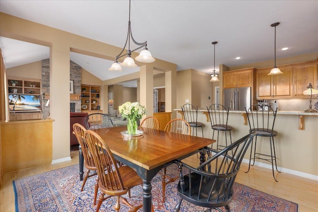 238 Muirfield Trl, Hudson, WI 54016 - dining room featuring lofted ceiling, light wood-style floors, built in shelves, and recessed lighting