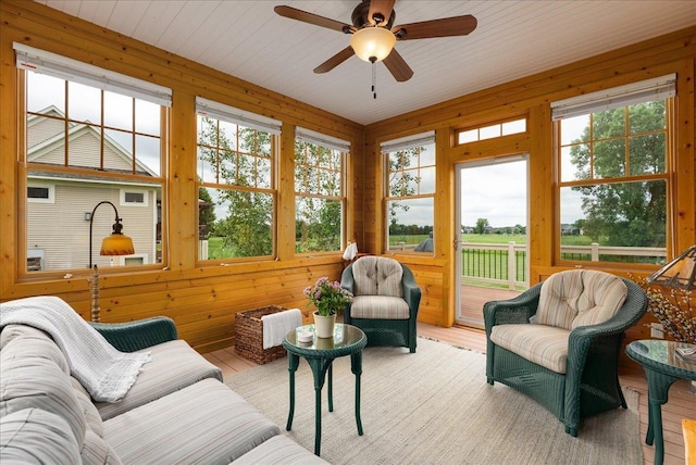 238 Muirfield Trl, Hudson, WI 54016 - sunroom / solarium featuring a deck, wood finished floors, healthy amount of natural light, and wood walls