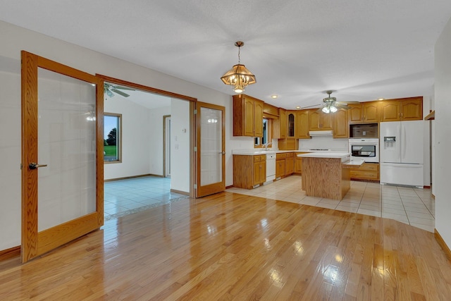 42767 190th Ave, Holding Twp, MN 56340 - kitchen with white appliances, light wood-type flooring, light countertops, ceiling fan, and a kitchen island