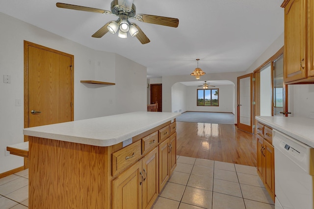42767 190th Ave, Holding Twp, MN 56340 - kitchen with white dishwasher, a ceiling fan, arched walkways, light countertops, and light tile patterned floors