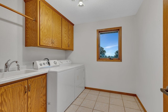 42767 190th Ave, Holding Twp, MN 56340 - laundry area featuring cabinet space, washer and dryer, a textured ceiling, and light tile patterned floors