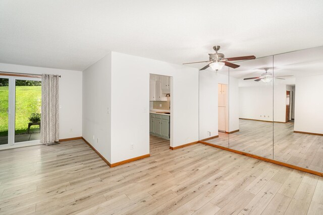 14381 Fairway Dr, Eden Prairie, MN 55344 - unfurnished living room featuring a ceiling fan and light wood-type flooring