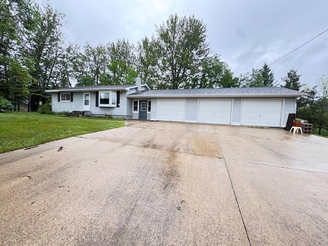 517 2nd St NW, Menahga, MN 56464 - view of front of home with a front yard, driveway, and a garage