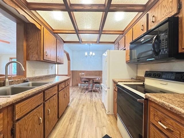 517 2nd St NW, Menahga, MN 56464 - kitchen featuring electric range oven, black microwave, light wood finished floors, a chandelier, and brown cabinets
