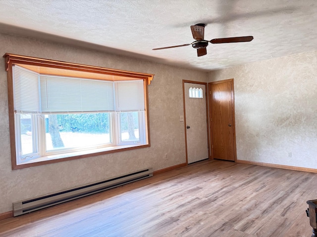 517 2nd St NW, Menahga, MN 56464 - entryway featuring a baseboard radiator, plenty of natural light, wood finished floors, a textured wall, and ceiling fan