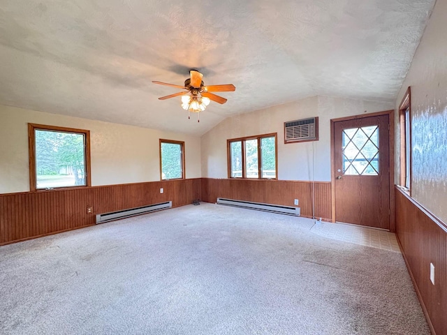 517 2nd St NW, Menahga, MN 56464 - unfurnished room with baseboard heating, lofted ceiling, a wainscoted wall, wooden walls, and an AC wall unit