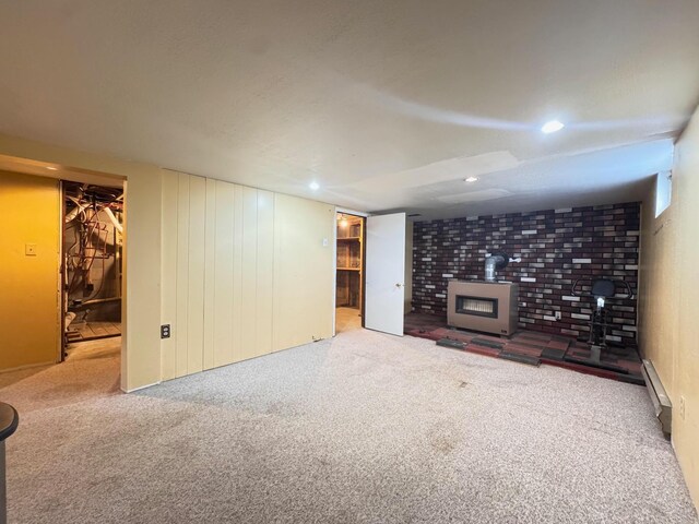 517 2nd St NW, Menahga, MN 56464 - unfurnished living room featuring a wood stove, baseboard heating, carpet flooring, and recessed lighting