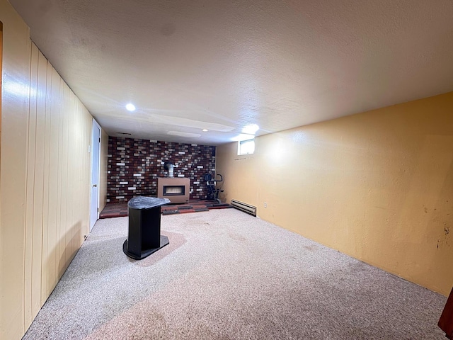 517 2nd St NW, Menahga, MN 56464 - basement with carpet flooring, baseboard heating, and a wood stove