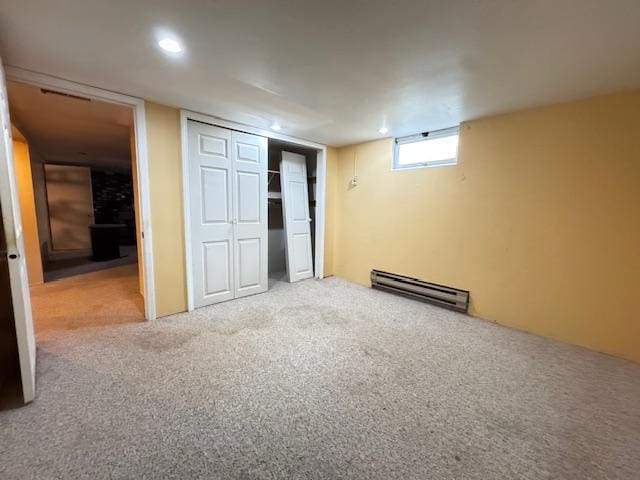 517 2nd St NW, Menahga, MN 56464 - below grade area featuring a baseboard heating unit and carpet