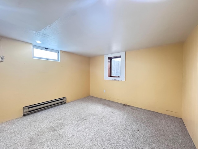 517 2nd St NW, Menahga, MN 56464 - below grade area with a baseboard radiator and carpet flooring