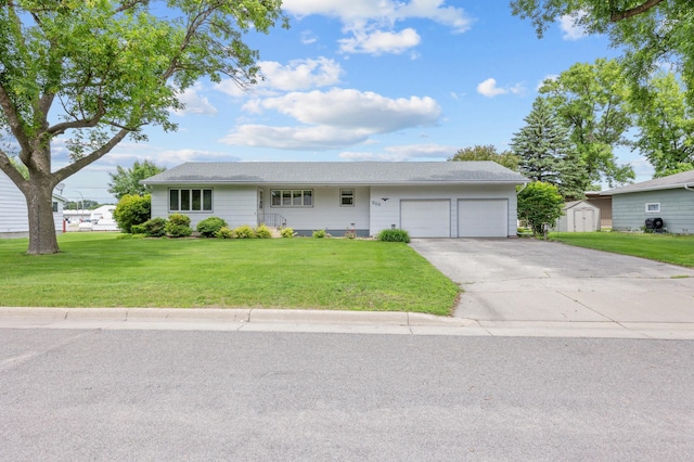 226 Ash Ave, Bird Island, MN 55310 - ranch-style house with an attached garage, a storage shed, a front yard, and driveway