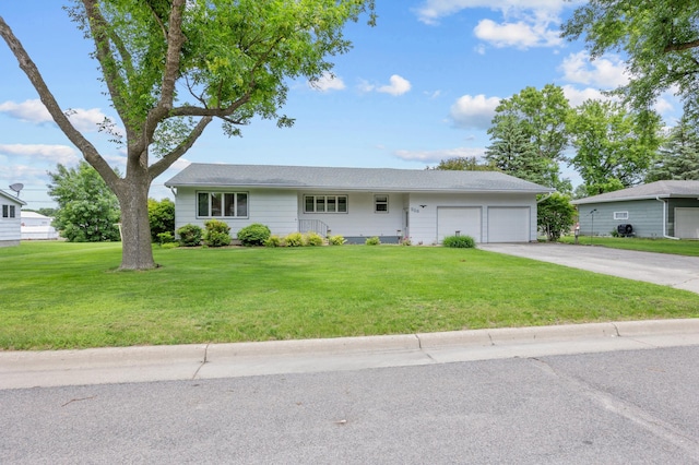 226 Ash Ave, Bird Island, MN 55310 - ranch-style home with an attached garage, concrete driveway, and a front lawn