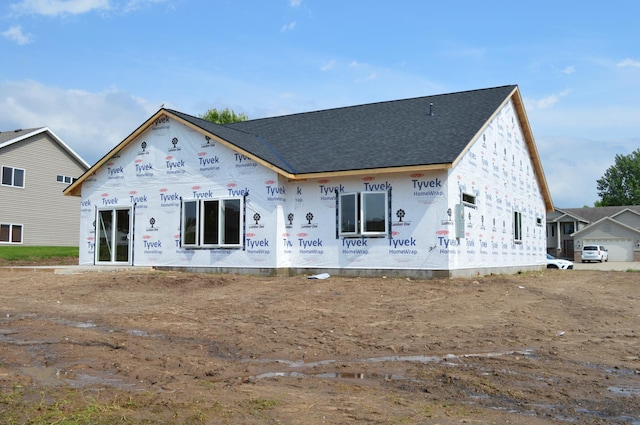 1303 Iris Ln, Saint Joseph, MN 56374 - back of house featuring roof with shingles