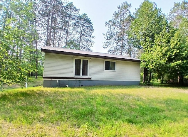 37059 Pinewood Dr, Lawrence Twp, MN 55709 - rear view of house featuring a yard and french doors