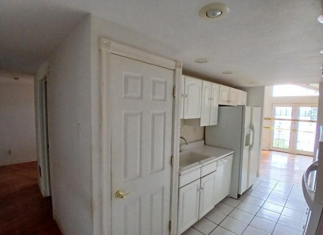 37059 Pinewood Dr, Lawrence Twp, MN 55709 - kitchen with white appliances, white cabinetry, light countertops, and light tile patterned floors