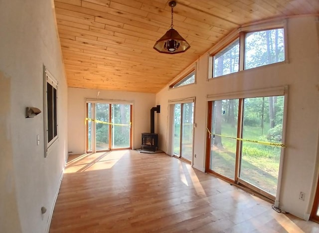 37059 Pinewood Dr, Lawrence Twp, MN 55709 - unfurnished sunroom featuring a wood stove and vaulted ceiling