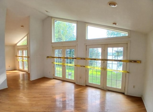 37059 Pinewood Dr, Lawrence Twp, MN 55709 - doorway with french doors, wood finished floors, and high vaulted ceiling