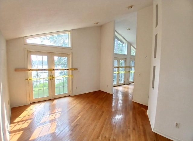 37059 Pinewood Dr, Lawrence Twp, MN 55709 - entryway featuring french doors, hardwood / wood-style flooring, and high vaulted ceiling