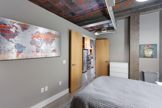 718 Washington Ave N Unit 612, Minneapolis, MN 55401 - bedroom with freestanding refrigerator and finished concrete flooring