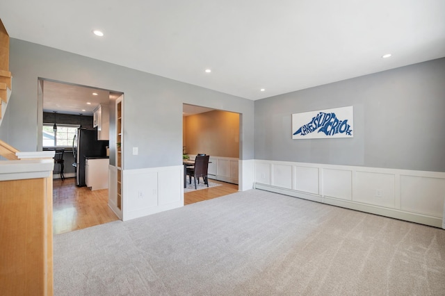 114 Chester Pkwy, Duluth, MN 55805 - unfurnished room with baseboard heating, a decorative wall, carpet, recessed lighting, and a wainscoted wall