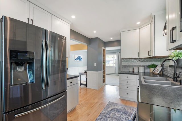 114 Chester Pkwy, Duluth, MN 55805 - kitchen with stainless steel fridge, dark countertops, light wood-type flooring, white cabinetry, and recessed lighting