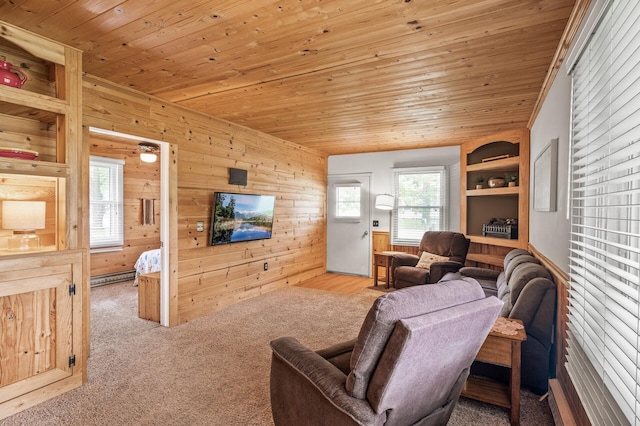 1015 Lake St N, Big Lake, MN 55309 - carpeted living room featuring wooden walls, wood ceiling, built in shelves, and a baseboard radiator