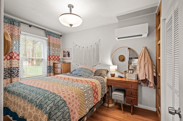 1015 Lake St N, Big Lake, MN 55309 - bedroom with a wall mounted air conditioner and wood finished floors