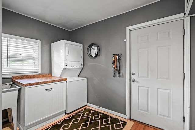 1015 Lake St N, Big Lake, MN 55309 - laundry room featuring stacked washing machine and dryer and cabinet space