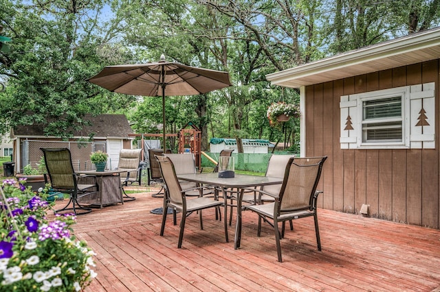 1015 Lake St N, Big Lake, MN 55309 - wooden deck with outdoor dining area and view of scattered trees