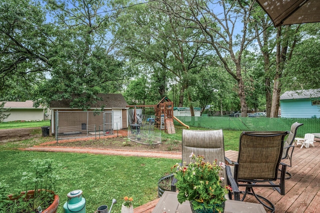 1015 Lake St N, Big Lake, MN 55309 - view of yard with a playground, a wooden deck, an outbuilding, and view of scattered trees