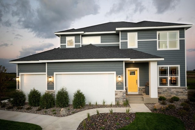 2963 Trinity Dr, Shakopee, MN 55379 - prairie-style home featuring a garage, stone siding, roof with shingles, and driveway