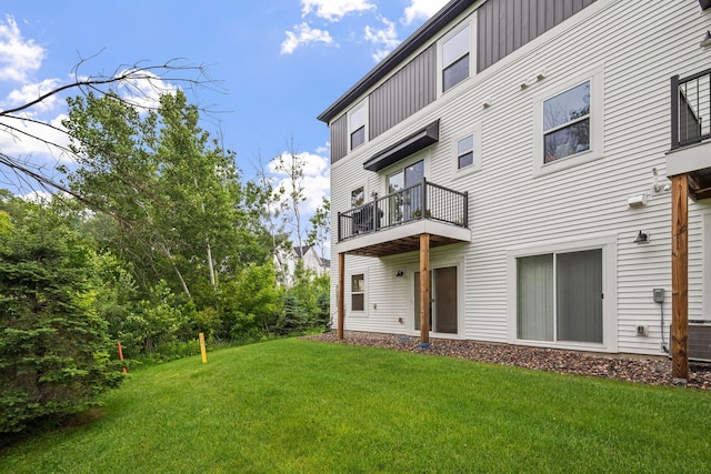 8612 Kenyon Ct NE Unit A, Blaine, MN 55449 - back of property featuring a balcony, board and batten siding, and a lawn