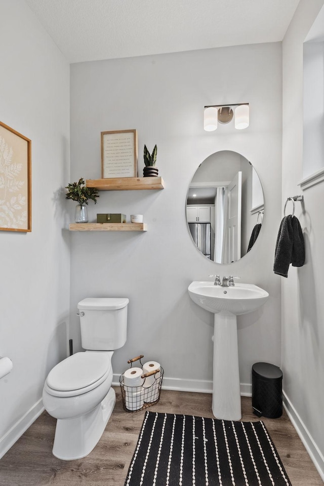 8612 Kenyon Ct NE Unit A, Blaine, MN 55449 - half bath with wood finished floors and toilet