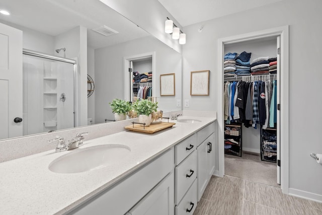 8612 Kenyon Ct NE Unit A, Blaine, MN 55449 - full bath featuring double vanity, a spacious closet, and a stall shower
